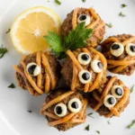 "Final plated Halloween mummy meatballs recipe with natural golden texture"